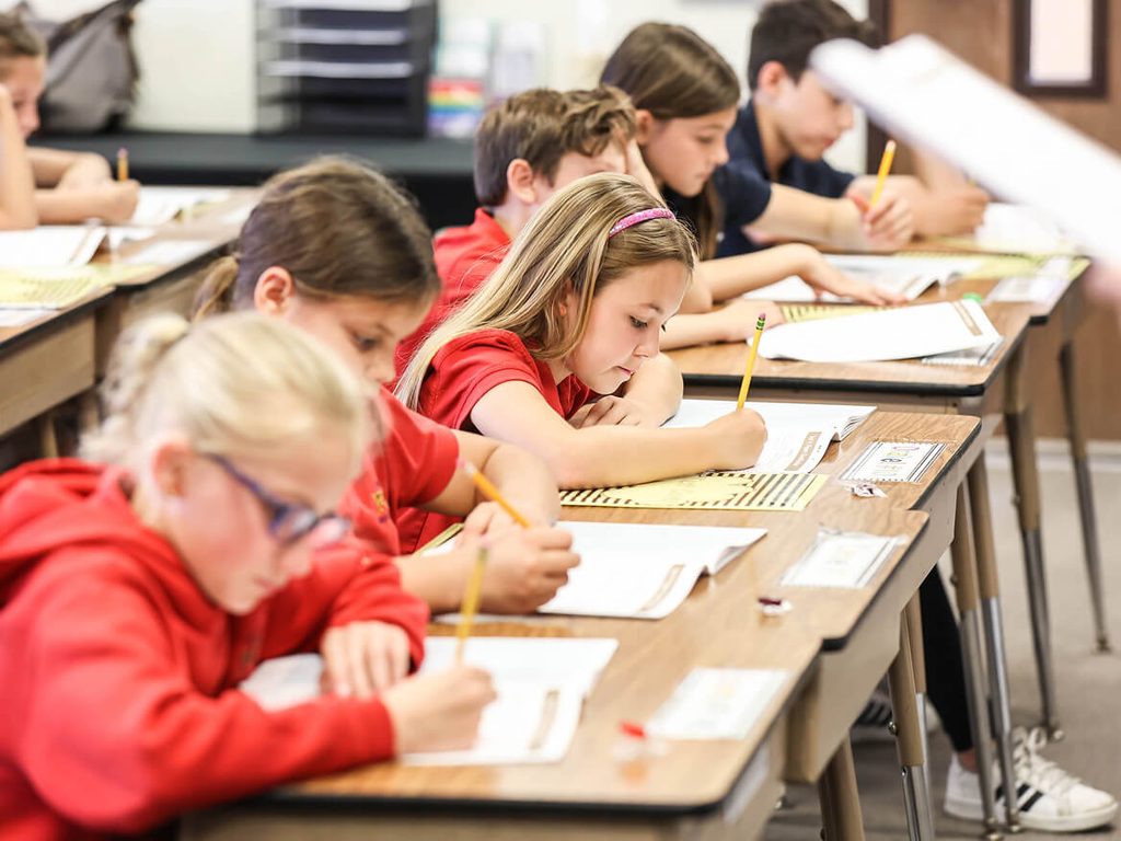 Students working on assignments at their desks during class