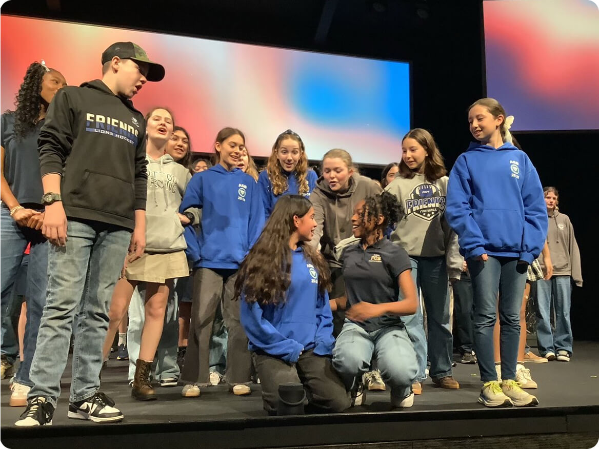 Middle school students on stage together during a performance