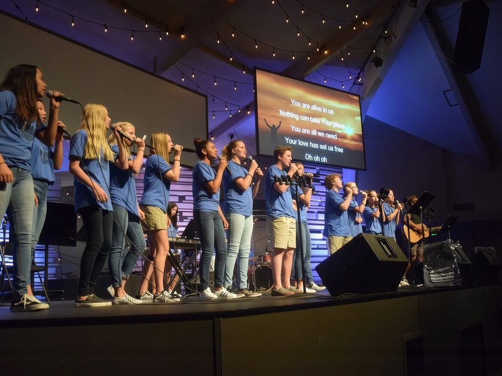 Students leading worship on stage during chapel